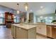 Open-concept kitchen with a center island, stainless steel appliances, and a view to the living room at 3089 Enisglen Dr, Palm Harbor, FL 34683