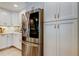 Modern kitchen featuring stainless steel refrigerator, white cabinets, and modern hardware at 3089 Enisglen Dr, Palm Harbor, FL 34683