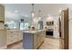 Bright kitchen features a center island, stainless appliances, and wood-look floors at 3089 Enisglen Dr, Palm Harbor, FL 34683