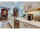 Bright kitchen features white cabinetry, stainless steel appliances, and elegant countertops at 3089 Enisglen Dr, Palm Harbor, FL 34683