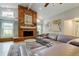 Spacious living room features brick fireplace, natural light, comfortable seating, and stylish decor at 3089 Enisglen Dr, Palm Harbor, FL 34683