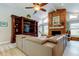 Comfortable living room with brick fireplace, entertainment center and a large, comfortable sofa at 3089 Enisglen Dr, Palm Harbor, FL 34683