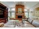 Spacious living room featuring a brick fireplace, entertainment center, and comfortable seating at 3089 Enisglen Dr, Palm Harbor, FL 34683