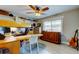 Bright office with ceiling fan, wood floors, built-in desk, shelves, and ample storage at 3089 Enisglen Dr, Palm Harbor, FL 34683