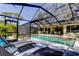 Beautiful backyard pool features screened-in lanai, with a spacious outdoor dining and living area at 3089 Enisglen Dr, Palm Harbor, FL 34683