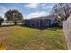 Expansive backyard featuring a well-maintained lawn and screened-in patio of the home at 3298 Buckhorn Dr, Clearwater, FL 33761