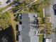 Aerial shot showcases the home's patio, manicured yard, and pond with fountain in a serene setting at 3401 Killdeer Pl, Palm Harbor, FL 34685