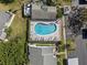 Aerial view shows a beautiful community pool with ample seating and manicured landscaping at 3401 Killdeer Pl, Palm Harbor, FL 34685