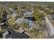 Aerial view highlighting the community pond with fountain, lush landscaping, and convenient parking at 3401 Killdeer Pl, Palm Harbor, FL 34685