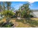 Lush backyard featuring patio furniture, a bird bath, and tropical plants at 3401 Killdeer Pl, Palm Harbor, FL 34685