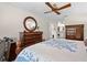 Bedroom showcasing wood furniture, a decorative mirror, and a view to the bathroom at 3401 Killdeer Pl, Palm Harbor, FL 34685