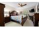 Bedroom with a king-size bed, ceiling fan, and a flat-screen TV at 3401 Killdeer Pl, Palm Harbor, FL 34685