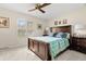 Comfortable bedroom featuring a wooden bed frame and a ceiling fan at 3401 Killdeer Pl, Palm Harbor, FL 34685