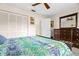 Comfortable bedroom with a large closet, dresser, and ceiling fan at 3401 Killdeer Pl, Palm Harbor, FL 34685