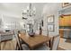 Open dining room showcasing a chandelier, wood floors, access to the kitchen and living room at 3401 Killdeer Pl, Palm Harbor, FL 34685