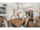 Bright dining room featuring a wood table, six chairs, chandelier, and access to the lanai at 3401 Killdeer Pl, Palm Harbor, FL 34685