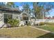 Charming single-story home featuring a beautifully landscaped front yard and a welcoming gated entryway at 3401 Killdeer Pl, Palm Harbor, FL 34685