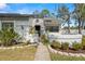 Charming single-story home featuring a beautifully landscaped front yard and a welcoming gated entryway at 3401 Killdeer Pl, Palm Harbor, FL 34685