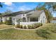 Charming single-story home featuring a beautifully landscaped front yard and a welcoming gated entryway at 3401 Killdeer Pl, Palm Harbor, FL 34685