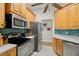 The kitchen includes stainless steel appliances, wood cabinets, and a tiled backsplash at 3401 Killdeer Pl, Palm Harbor, FL 34685