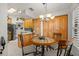 Charming kitchen with stainless steel appliances, wood cabinets, and a cozy breakfast nook at 3401 Killdeer Pl, Palm Harbor, FL 34685