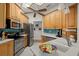 Well-lit kitchen features stainless steel appliances, wood cabinets, and a stylish backsplash at 3401 Killdeer Pl, Palm Harbor, FL 34685