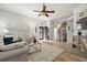 Stylish living room with hardwood floors, comfortable seating, and natural light streaming through shuttered windows at 3401 Killdeer Pl, Palm Harbor, FL 34685