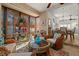 Inviting sunroom featuring wicker furniture and a view into the dining room at 3401 Killdeer Pl, Palm Harbor, FL 34685