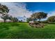 Welcoming entrance to Highland Lakes Club with manicured landscaping, flowers, and an American flag at 3546 Birkdale Ln, Palm Harbor, FL 34684