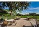 Charming outdoor patio with tables, chairs, and umbrellas overlooking a golf course at 3546 Birkdale Ln, Palm Harbor, FL 34684