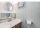 Well-lit bathroom featuring a sink vanity, round mirror, and a fresh, clean design at 37321 8Th Ave, Zephyrhills, FL 33542