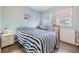 Bright bedroom with wood flooring, two bright windows, and beach decor at 37321 8Th Ave, Zephyrhills, FL 33542