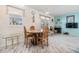 Bright dining area with a round wood table, light walls, and updated flooring at 37321 8Th Ave, Zephyrhills, FL 33542