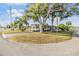 Well-maintained home on a corner lot, showcasing mature trees and a charming exterior at 37321 8Th Ave, Zephyrhills, FL 33542