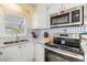 Bright kitchen boasts stainless steel appliances, stylish countertops, and a corner sink at 37321 8Th Ave, Zephyrhills, FL 33542