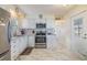Galley kitchen features white cabinets, stainless steel appliances, and stylish countertop at 37321 8Th Ave, Zephyrhills, FL 33542