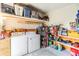 Functional laundry area with washer, dryer, shelving, and storage for organization and convenience at 37321 8Th Ave, Zephyrhills, FL 33542