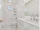 Bright bathroom with white tile, vanity, shower-tub combo, and natural light at 4610 W Browning Ave, Tampa, FL 33629