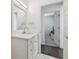 Bright and airy bathroom with white cabinets, modern vanity, and an entrance to a bedroom at 4610 W Browning Ave, Tampa, FL 33629