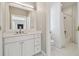 Bright bathroom featuring a white vanity with a square mirror and tile flooring at 4610 W Browning Ave, Tampa, FL 33629
