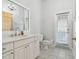 Bright bathroom featuring a white vanity, a mirror, tile flooring, and an exterior door at 4610 W Browning Ave, Tampa, FL 33629