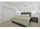 Bedroom featuring neutral carpet, ceiling fan, a large closet, and an ensuite bathroom at 4610 W Browning Ave, Tampa, FL 33629