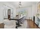 Bright dining room with table, clear chairs, decorative light fixture, and modern decor at 4610 W Browning Ave, Tampa, FL 33629