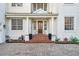 Home's stately front entrance featuring brick steps, white columns, and a wood door at 4610 W Browning Ave, Tampa, FL 33629