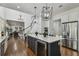 Bright open kitchen with island, wine cooler, stainless appliances, and access to living area and staircase at 4610 W Browning Ave, Tampa, FL 33629