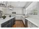 Bright kitchen featuring white and dark cabinets, stainless steel appliances, and hardwood floors at 4610 W Browning Ave, Tampa, FL 33629