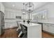 Kitchen with gray cabinetry, white counters, stainless steel appliances, and modern lighting at 4610 W Browning Ave, Tampa, FL 33629