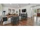 Cozy living room with hardwood floors, stylish furniture, a TV, and access to other rooms at 4610 W Browning Ave, Tampa, FL 33629