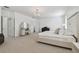 Large main bedroom featuring neutral decor, carpet, vanity area, and sitting area at 4610 W Browning Ave, Tampa, FL 33629