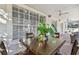 Covered patio with brick flooring, a wooden table, and large sliding glass windows at 4610 W Browning Ave, Tampa, FL 33629